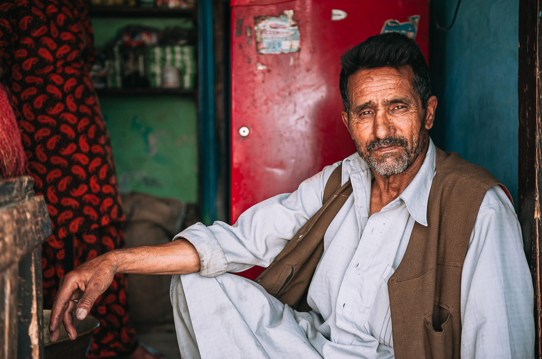 Ghulam Nabi (Shamima's father-in-law) runs a small shop set up by the entrance of his house