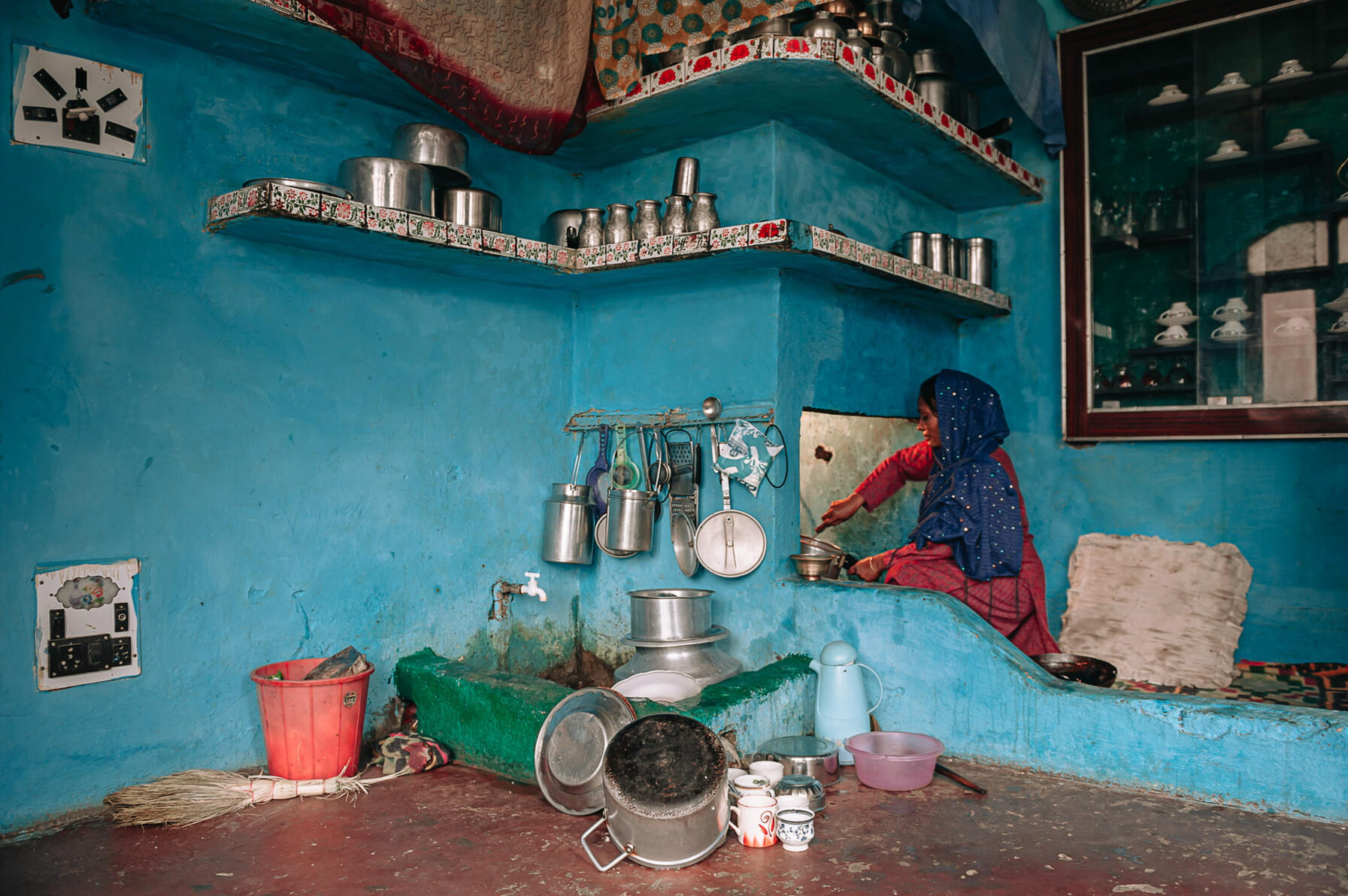 Ghulam Nabi's second wife prepares a meal in her kitchen on the ground floor of their three-storey house