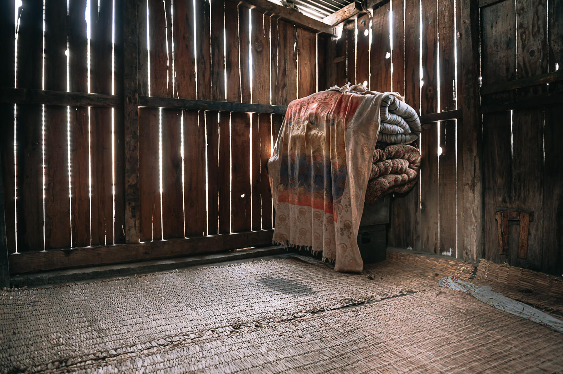 Shamima's bedroom, which she shares with Waseem and Bisma, is almost completely bare except for some mattresses and two boxes of personal items